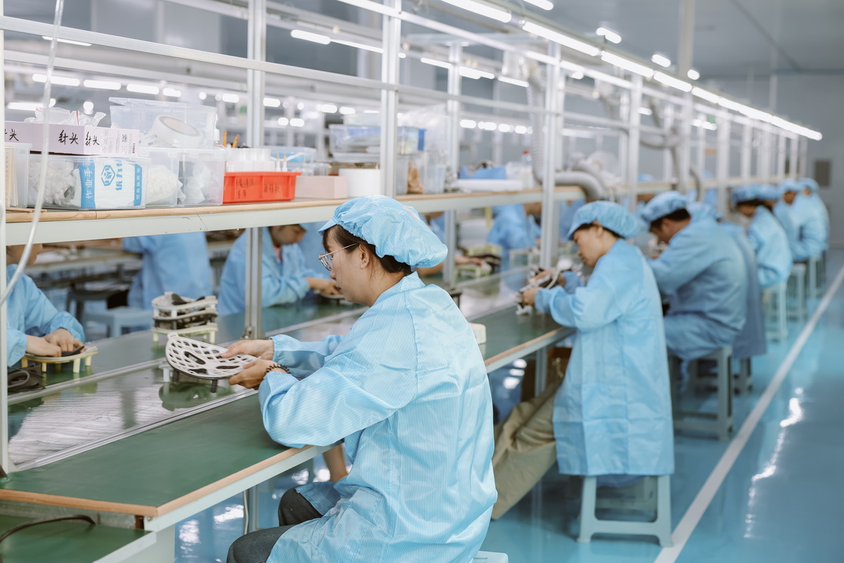 Assembly Line Workers Producing Led Red Light Therapy Masks.jpg